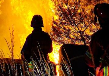 Firefighters battle a wild fire